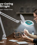 Person using clamp on magnifying lamp with 7 inch glass lens 5 diopter 6500K daylight LED glare free adjustable arm for crafting