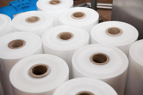 Rock Solid Heavy Duty Stretch Film Rolls For Machines, Clear 80 Gauge secure packing rolls stacked for industrial wrapping.