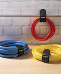 Elastic Cinch Straps With Anti Slip Strips 12 Inch Long 2 Inch Wide Eight Pack on coiled red, blue, and yellow hoses