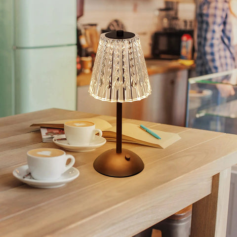 Cordless LED Table Lamp With 4000mAh Rechargeable Battery, on a dining table with coffee cups, crystal shade, black base.
