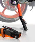 Portable Motorcycle Maintenance Stand With Adjustable Height Lift For Chain Cleaning And Lubrication next to motorcycle wheel