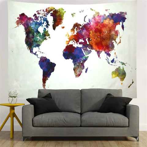Colorful watercolor world map tapestry for home and classroom above a grey sofa, educational wall decor on lightweight polyester.