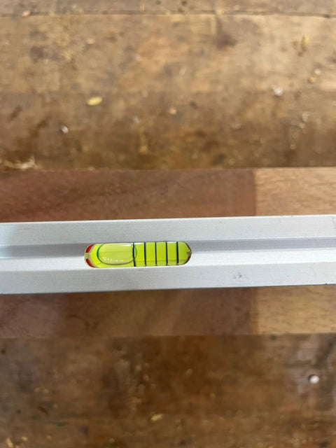 Close-up of Built Tough 12 Inch Magnetic Toolbox Level with Aluminum Frame and vial, showing precision measurement.