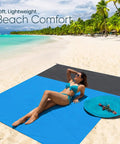 Woman lounging on a Sandproof Waterproof Beach Blanket, Extra Large 79x55 Inch Outdoor Mat For 1-4 Adults at a sunny beach