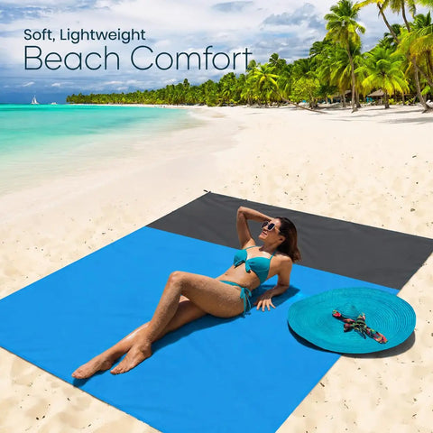 Woman lounging on a Sandproof Waterproof Beach Blanket, Extra Large 79x55 Inch Outdoor Mat For 1-4 Adults at a sunny beach