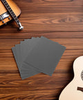Guitar Fretboard Protector Kit With Metal Fretboard Guards And Sandpaper Sheets For Precision Smoothing And Safe Fret Maintenance And Repair Includes Durable Metal Shields And Fine Polishing Papers For Clean Edges And Pro Grade Guitar Care. metal guards and sanding sheets on wood table