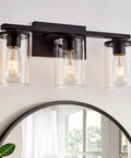 Matte Black Four Light Vanity Fixture with Clear Glass Shades over a mirror, modern wall sconce for bathroom, sleek and elegant