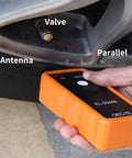 Professional TPMS Relearn Tool For Tire Pressure Monitor Activation And Universal Sensor Reset Straight Shooter Diagnostics in hand near valve.