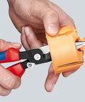 Using Electrical Installation Pliers 6 In 1 Multi Function Tool With Red Plastic Coated Handles And Black Atramentized Finish on an orange object