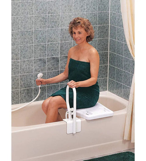 Woman sitting on tub seat holding White Bathtub Rail With Wide Grip For Bathroom Safety, Shower Handle, and Bathtub Bar Clamp.