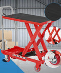 Front view of red heavy-duty hydraulic lift table cart with black non-slip platform and locking wheels