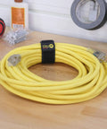 Selfie Straps 12 Inch 8 Pack Black Super Handy Stretchy Hook and Loop Cord Organizer securing a yellow extension cord