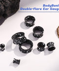 Silicone Ear Gauges 00G Double Flared Plugs Set for Ear Stretching, black with white speckles, laid out on white surface.