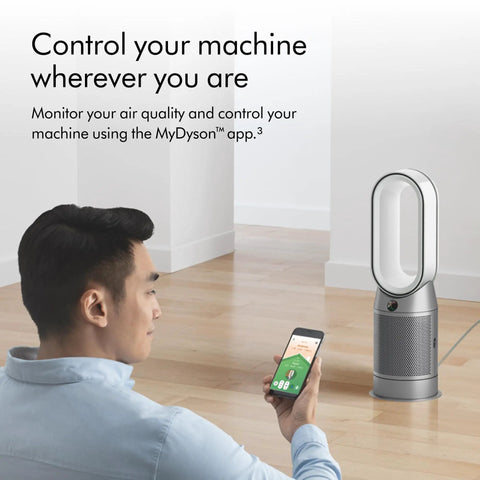 Person using smartphone with Hot And Cool HP07 Air Purifier With Heater And Fan, All In One Climate Control visible in room