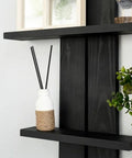 Decorative shelf with No Drama Peel And Stick Black PVC Wallpaper Roll For Home Office DIY Room Glow Up, featuring black reed sticks.