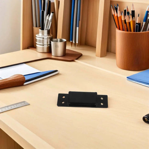 Hidden Door Hinge 5 Inch Black Concealed Pivot for Cabinets and Secret Doors sitting on a wooden desk