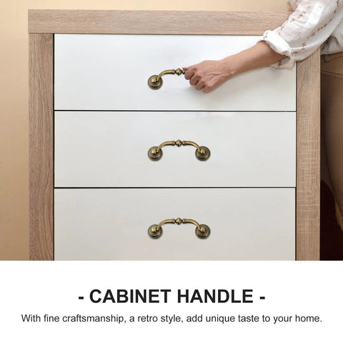 Hand using 4 Pack Vintage European Style Cabinet Drawer Pulls Antique Bronze Wardrobe Door Handles For Home Decor Retro Farmhouse