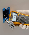 Hand using Digital Multimeter With Non Contact Voltage Detection VoltAlert Technology AutoVolt Automatic AC And DC Voltage Selection