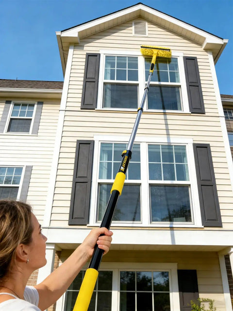 Person using Heavy-Duty Commercial Extension Pole Delivers 4.5 To 18 Ft Reach For True Two-Story Access Up To 24 Ft Total on house exterior.
