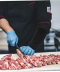 Heavy Duty Kickass Cut Resistant Arm Sleeves Lightweight Protective Gear Breathable Polymer Fabric Anti Scratch Guard Tough On Sparks And Jagged Steel Built For Welding Yard Or Auto Shop Grind worn by chef cutting meat.