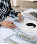 Heavy Duty Cash Strapping Tape Roll For Banknote Bundling And Shipping on desk with currency