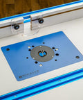 Top view of a Phenolic Router Plate B for Easy Lift and Quick Bit Changes on Your Router Table, installed in a wood table setup.