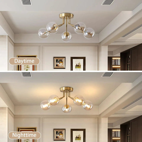 Day and night view of gold five light Sputnik style ceiling light semi flush mount with glass globe pendant lamps