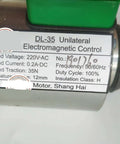 Close-up of AC220V Escalator Brake Electromagnet Spare Part label with specifications and manufacturing details