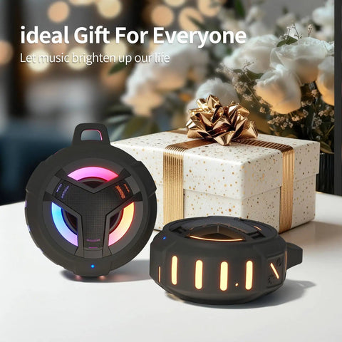 Bluetooth Shower Speaker With LED Light, IP67 Waterproof And Floating, in front of a gift box, showing glowing LED lights.