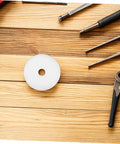 Heavy Hitter Nylon Pulley Wheels With Precision Ball Bearings Smooth Gliding Caster Rollers on a wood surface with tools.