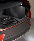Portable EV Charger With 12 Amp Output, 25 Ft Rugged Cable in car trunk; SAE J1772 Connector, Indoor Outdoor Use, 120V NEMA 5 15 Plug visible