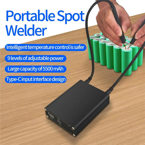 Portable spot welder on table with connected welding pen, showing features of Handheld Mini Spot Welder Kit For DIY Projects