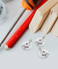 Set Of 20 Metal Thumb Nuts For Hurricane Shutters With Washered Backplates, displayed with tools and wooden blocks