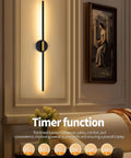 Black And Gold Rechargeable Wall Sconce Set Of Two with timer function installed on a beige wall, providing warm ambient light.