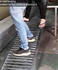 Light Duty Unpowered Roller Conveyor For Warehouses And Factories With Galvanized Steel Rollers Splicable Bucket Unloading Pulley And 30Cm To 120Cm Wide Durable Widths For Easy Material Handling used as a load test by two adults