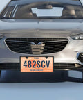 Car front view with stainless steel license plate frame with slim two hole design flat plate holder that keeps it clean and rust free weatherproof car accessory with metal screw caps black finish narrow frame for standard plates