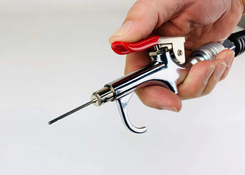 Close-up of blow gun with nozzle from Deluxe One Quarter Inch Air Compressor Accessory Kit with Twenty Five Foot Recoil Hose and accessories.