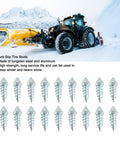 Heavy Duty Winter Tire Spikes With Solid Tungsten Steel Tips And Rugged Aluminum Construction M8 Thread 100 Piece Set displayed with tractor in snow.