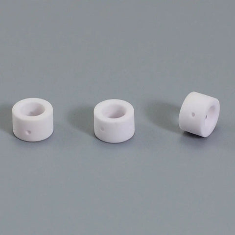 Three ceramic cups from Pro Grade Plasma Cutting Torch Consumables Kit For PT 31 LG 40 JG 40 Featuring Nickel Plated Tips Extended Nozzles