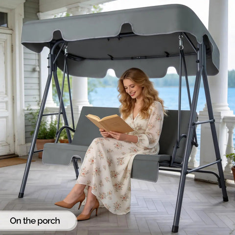 Outdoor Porch Swing With Adjustable Canopy And Durable Steel Frame On Heavy Duty Stand in use on a porch, woman reading book.
