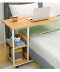 C Shaped Bedside Table With Heavy Duty Wheels And Locks Height Adjustable Laptop Workstation Sofa Snack Tray Overbed Cart For Bedroom Living Room Couch Straight Up Game Changer beside a bed with a laptop and coffee.