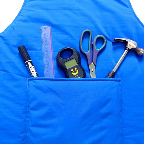 Cryogenic Lab Apron For Liquid Nitrogen Protection, blue apron with pocket containing tools, visible nylon Taslan outer layer.