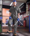 Men's Short Sleeve Coveralls Lightweight Breathable Mechanic Work Jumpsuit Summer Grind Threads worn by a mechanic in a garage.