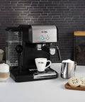 Your New Favorite Hustle Free Automatic Espresso And Cappuccino Maker Featuring Boss Level 15 Bar Pressure And Thermal Heating For Truly On Point Lattes In Silver And Black with cappuccino cups and frother.