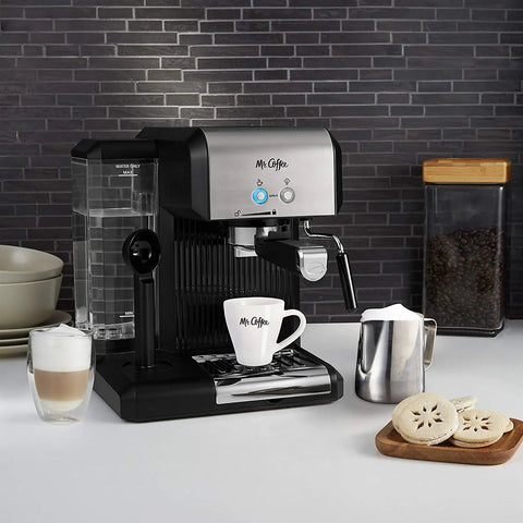 Your New Favorite Hustle Free Automatic Espresso And Cappuccino Maker Featuring Boss Level 15 Bar Pressure And Thermal Heating For Truly On Point Lattes In Silver And Black with cappuccino cups and frother.