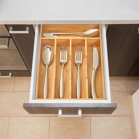 Premium Bamboo Kitchen Drawer Organizer Nine Inch Silverware Tray with cutlery arranged in a bamboo caddy.