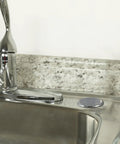 Chrome Kitchen Sink Hole Cover That Hides Unused Holes From Sprayer Or Soap Dispenser Rust Resistant No Tools Needed Easy To Install Durable Sink Plug Cover For A Sleek And Discreet Look displayed next to a faucet.