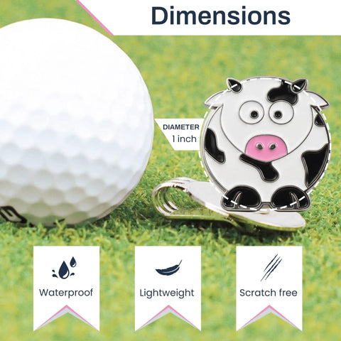 Cow Shaped Golf Ball Marker With Hat Clip Cute Durable Metal Golf Accessory For Women Golfers Fun Gift Idea Easy Hat Clip Attachment Keeps Your Mark In Style On The Green next to golf ball on grass
