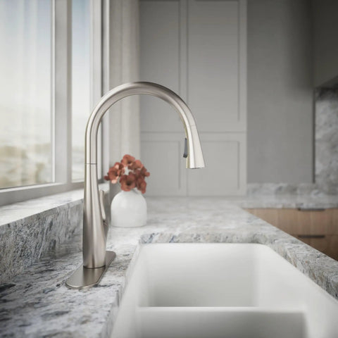 Top Shelf Pull Down Kitchen Sink Faucet With Smooth Glide Retractable Hose And Dual Function Sweep Sprayhead Built Tough For Lightning Fast Cleanup In Classic Vibrant Stainless Finish installed on a modern countertop with a white sink.