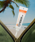 4 Pack Zipper Lubricant Waterproof Wax and Grease for Metal and Plastic Zippers with beach background and palm tree